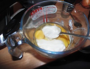 Adding Creme Fraiché to the eggs for the filling of the Courgette, Saffron and Two Cheese Tart