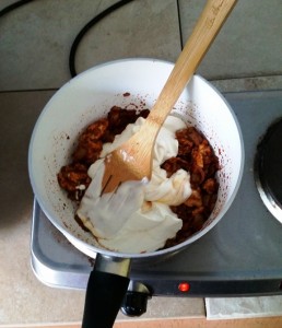 Adding the Crème Fraiche to the Saucepan of ingredients for my Mystery Bag Meals – Chicken Stroganoff Pie