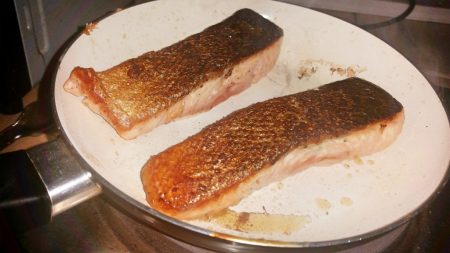 Cajun Salmon on a Mediterranean Sauce - Turn the fish over and cook further