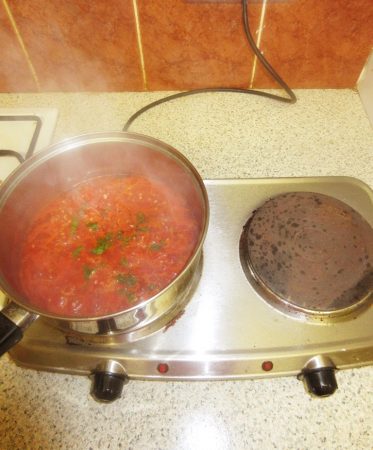 Theo Randall's Tomato Risotto - Finishing off the tomato sauce by tearing up some basil leaves