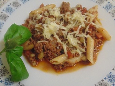 The Bolognese Sauce served with Pene Pasta and topped with Cheddar Cheese