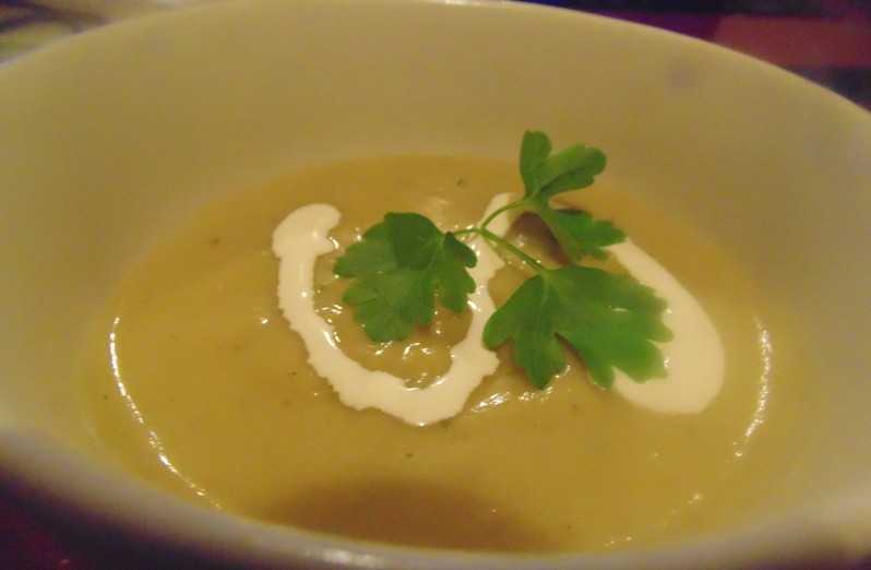 Leek and Potato Soup with a Swirl of Cream and Parsley Leaf