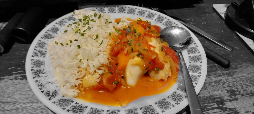 Black and white surround with coloured food and cuttlery The meal served on a plate in the lounge